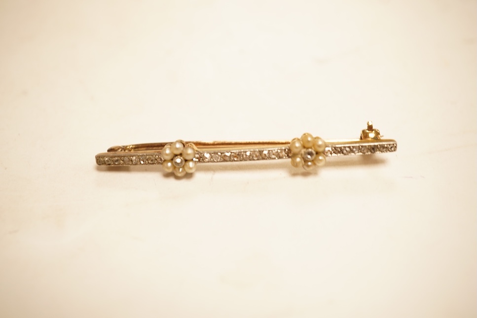 An Edwardian yellow metal, seed pearl and millegrain set diamond bar brooch, 51mm, gross weight 2.9 grams.